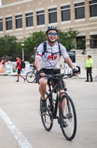 Dr. Nguyen riding a bike, promoting physical activity and a healthy lifestyle for Men's Health Month.